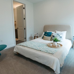 a bedroom with a bed and chair