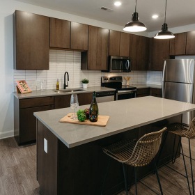 a kitchen with an island and chairs